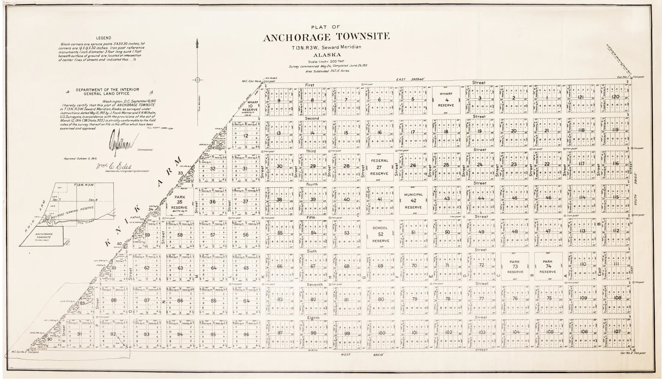1915 plat of Anchorage Townsite showing numbered blocks, streets, public reserves, wharf areas, and the Knik Arm shoreline.